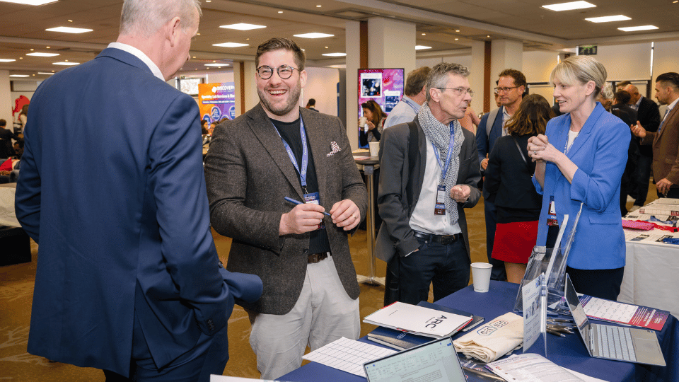Sponsor representative engaging with attendees at World CNS Korea